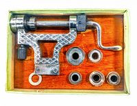 Top view of mainspring winder and five interchangeable barrels in original wooden insert inside box