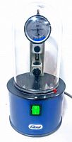 Full unit front view showing blue metal base, green rocker switch, clear plastic dome and attached gauge and connectors