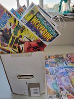 Front view of long box filled with comics showing covers like Marvel Comics Presents Wolverine and others.