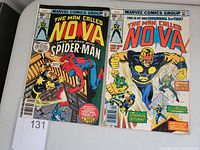 Photo of front covers for The Man Called Nova issues #12 and #13 showing colorful cover art and titles.