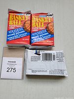 Photo showing three unopened jumbo packs of 1991-92 Fleer Basketball Player Photo Cards, each pack with 48 cards. The packaging highlights new series featuring Dikembe Mutombo and Dominique Wilkins, limited edition subsets, and retail price stickers.