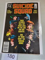 Front cover showing Suicide Squad #1 with art and text colors in good detail, inside plastic protective sleeve.