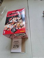 Photo of sealed, unopened box of 2019 NBA Champions Toronto Raptors basketball cards by Panini, showing front of box with player imagery and branding.
