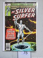 Front cover of the vintage Marvel comic book Fantasy Masterpieces #1 starring The Silver Surfer, showing the character standing above Earth and the story headline 'The Origin of The Silver Surfer'.