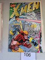 Front cover of X-Men #1 comic book showing Cyclops firing laser beam and Wolverine in action pose.