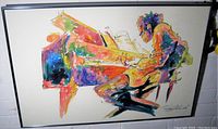 Frontal view of the framed painting showing abstract piano player in vibrant colors.