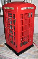 Front side view of the illuminated miniature British telephone booth showing the phone inside and 'TELEPHONE' label on top.