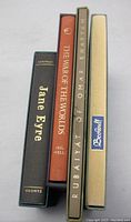 Photo of the four book spines showing titles Jane Eyre, The War Of The Worlds, Rubaiyat of Omar Khayyam, Beowulf