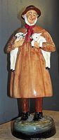 Front view of the Royal Doulton Lambing Time HN 1890 figurine, showing the man holding two lambs.