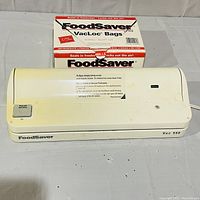 Full view of Foodsaver Vac 550 vacuum sealer and box of VacLoc bags