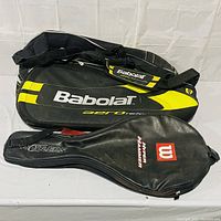 Babolat Aero and Wilson Hammer tennis racket bags stacked, visible logos and colors.
