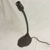 Full view of vintage metal lamp showing the flexible gooseneck and patterned base.
