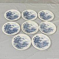 Full set of 8 blue and white Wedgwood plates arranged showing consistent design.