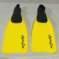 Top view of the yellow Hydro-Lite swimming flippers showing the black foot pockets and Hydro-Lite branding on the blades.