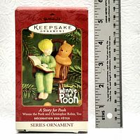 Original packaging of the Hallmark Keepsake Ornament A Story for Pooh featuring Winnie the Pooh and Christopher Robin Too with ruler for scale, measuring about 6 inches tall packaging.