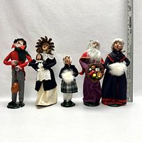 Photo of five Byers' Choice The Carolers 1992 figurines displayed with a ruler showing approximate height.