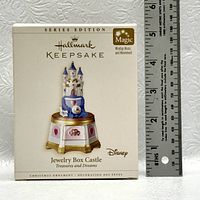 Photo of the front of the Hallmark Keepsake Jewelry Box Castle ornament box next to a ruler for size reference.