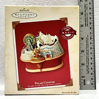 Boxed Hallmark Keepsake Ornament named Polar Coaster with size reference from ruler.
