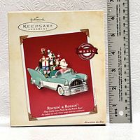 Photo of Hallmark Keepsake ornament box showing product image, showing teal vintage car with Santa and Christmas gifts, includes motion, magic lights and sound, and plays 'Little Saint Nick' by Beach Boys