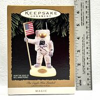 Original box of Hallmark Keepsake Ornament titled 'The Eagle Has Landed' featuring an astronaut holding an American flag with light and voice features.