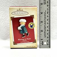 Photo of the Hallmark Keepsake Ornament box with Winter in Paris Madeline image visible and a ruler for size reference.