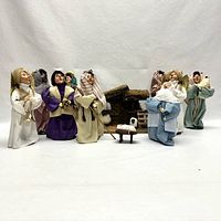 Front view of nativity set featuring stable backdrop, figurines and accessories arranged