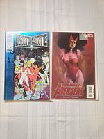 Two comic books laid flat: Deathmate and The New Avengers, showing illustrated covers and good physical condition.