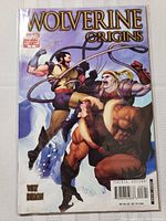 Front cover of Wolverine Origins Marvel variant comic showing Wolverine and other characters in action fight scene.