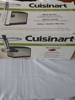 Full view of the Cuisinart meat grinder box showing brand, product image, and model number CMG-105C.