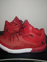 Side profile of the pair of red Nike Flight basketball shoes showing the Jumpman logo on the heel and midsole air unit