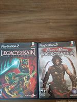 Front cover display of two PS2 game cases: Legacy of Kain Defiance and Prince of Persia Warrior Within