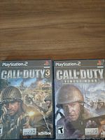 Front cover of Call of Duty 3 and Call of Duty Finest Hour PS2 games showing their front artwork and condition.