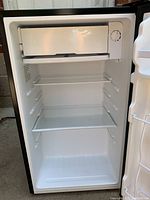 Interior fridge compartment showing shelves and freezer.