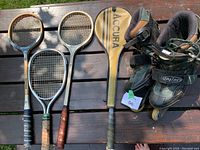 Photo of racquets and inline skates on wooden table showing condition and included items