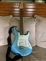 Full view of metallic blue Yamaha Pacifica electric guitar with strap