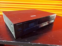 Front angled view showing Kenwood and product model details, 6-CD changer interface with buttons and display