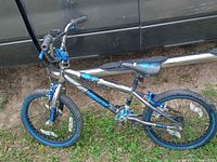 Side view of the MADDGEAR BMX bike showing frame, tires, and handlebar details.