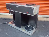 Front and side view of commercial Bunn VPS coffee maker showing dual hot plates and control panel.