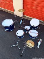Overhead view of all drums, cymbals, stands and pedal on asphalt