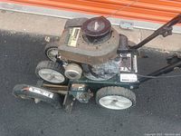 Side view of the Bolens lawn edger showing engine and wheels