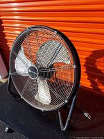 Front angle view of Utilitech heavy-duty fan showing metal cage, blades, and power cord.