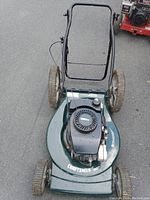 Top-down photo of the green Craftsman lawn mower showing the engine and cutting deck
