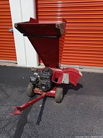 Front view of red hopper, engine and tow bar
