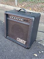 Side-angle view of Crate JX15R amplifier showing the textured black exterior, control knobs, and Crate logo on the speaker grille.