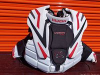 Front view of Vaughn 9400 Vision goalie chest and arm protector showing white, black, and red protective padding.