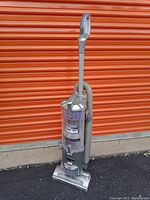 Front angled view of Shark Navigator vacuum showing clear dustbin and handle.