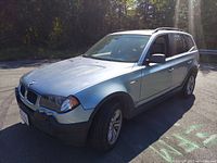 Front passenger-side exterior view showing front fascia, hood, windshield, passenger door and alloy wheel
