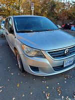 Front three-quarter view of silver exterior showing front bumper, grille, headlights and VW badge