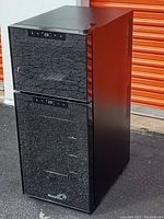 Front view of black Wine Enthusiast wine cooler with closed dual glass doors and digital temperature displays on each compartment.