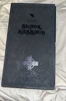 Top view of Black Sabbath Black Box showing embossed designs, band logo, and metallic cross marking 1970-1978.